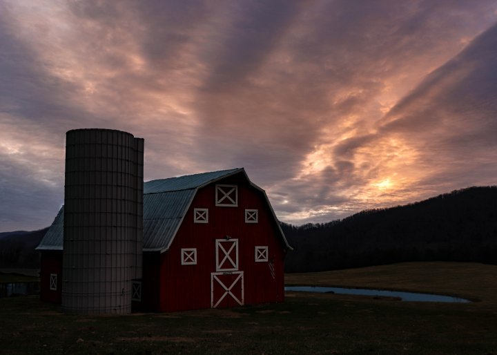 a farm at sunset