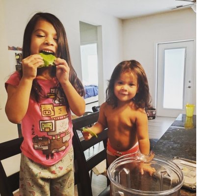 siblings enjoy their lettuce harvest