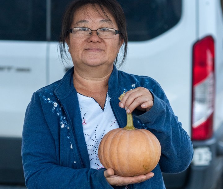 Chue Lee with a Cinderella pumpkin from Lee's One Fortune Farm