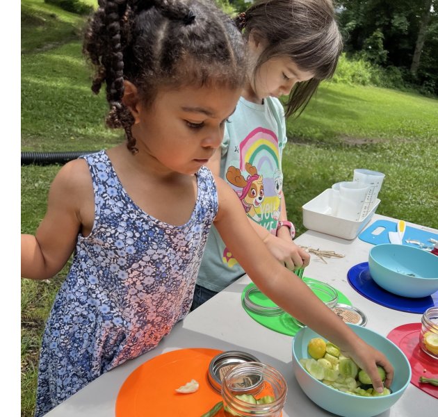 ASAP's BusStudents at Pisgah Collective explore the cucumber harvest from their new garden beds with a lesson in pickling.iness of Farming Conference, Feb. 11, 2023