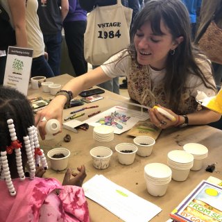 ASAP intern Maeve Woollen does a seed activity at the YWCA of Asheville.