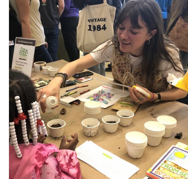 ASAP intern Maeve Woollen does a seed activity at the YWCA of Asheville.