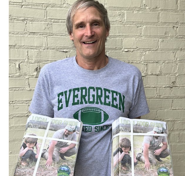Stephen Triplett with stacks of Local Food Guides