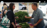 Lisa Payne and Stacy Dean in front of Growing Minds Meet Your Farmer banners at Weaverville Primary