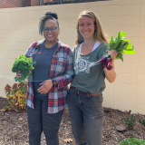 Melinda Aponte of YWCA and Hannah Jeske of R Farm holding produce