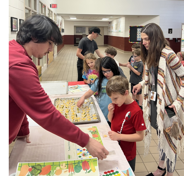 Pisgah High School CTE students offer taste tests to their elementary school classmates.